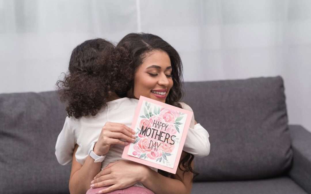 small child hugging her mom after gifting her a mother's day card, mothers day gift idea, daughter hugging her mom