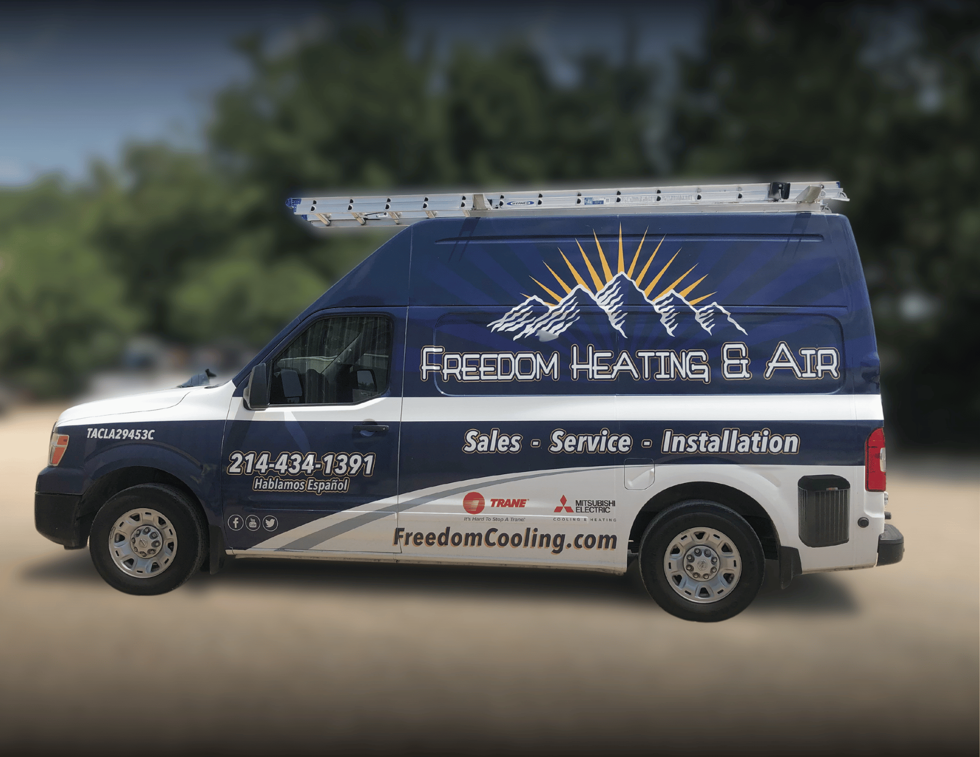 Freedom Heating & Air blue work vehicle that is wrapped with the company logo and contact details