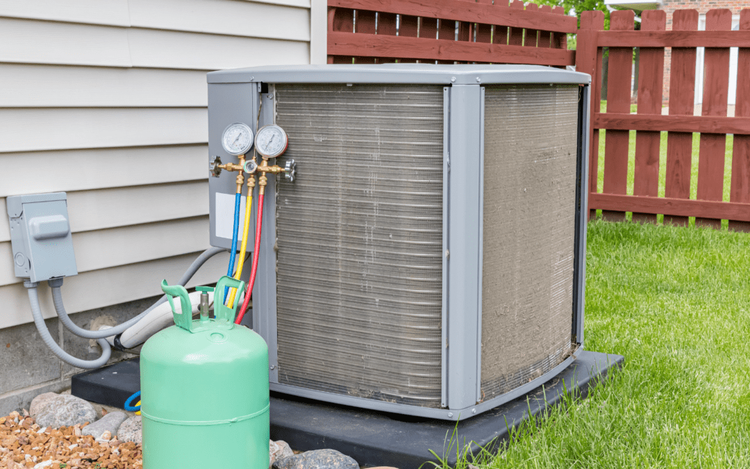 dirty air conditioning system with a layer of cottonwood outside a residential home with gauges attached and a visible refrigerant tank next to the hvac unit